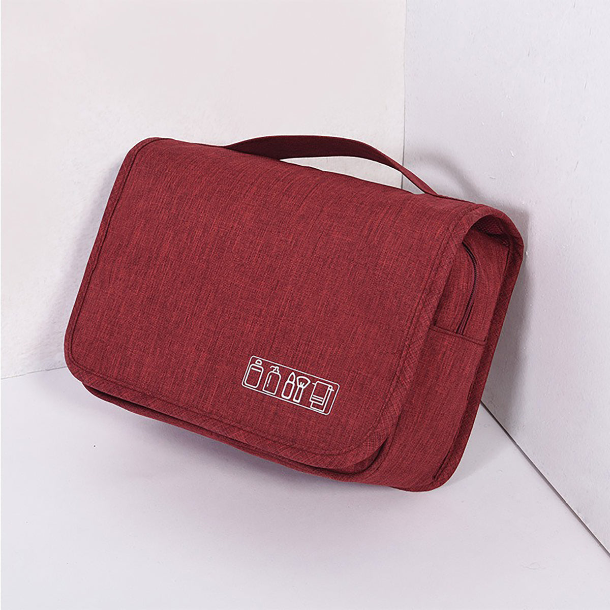 Red hanging toiletry bag, folded, with a top carry handle
