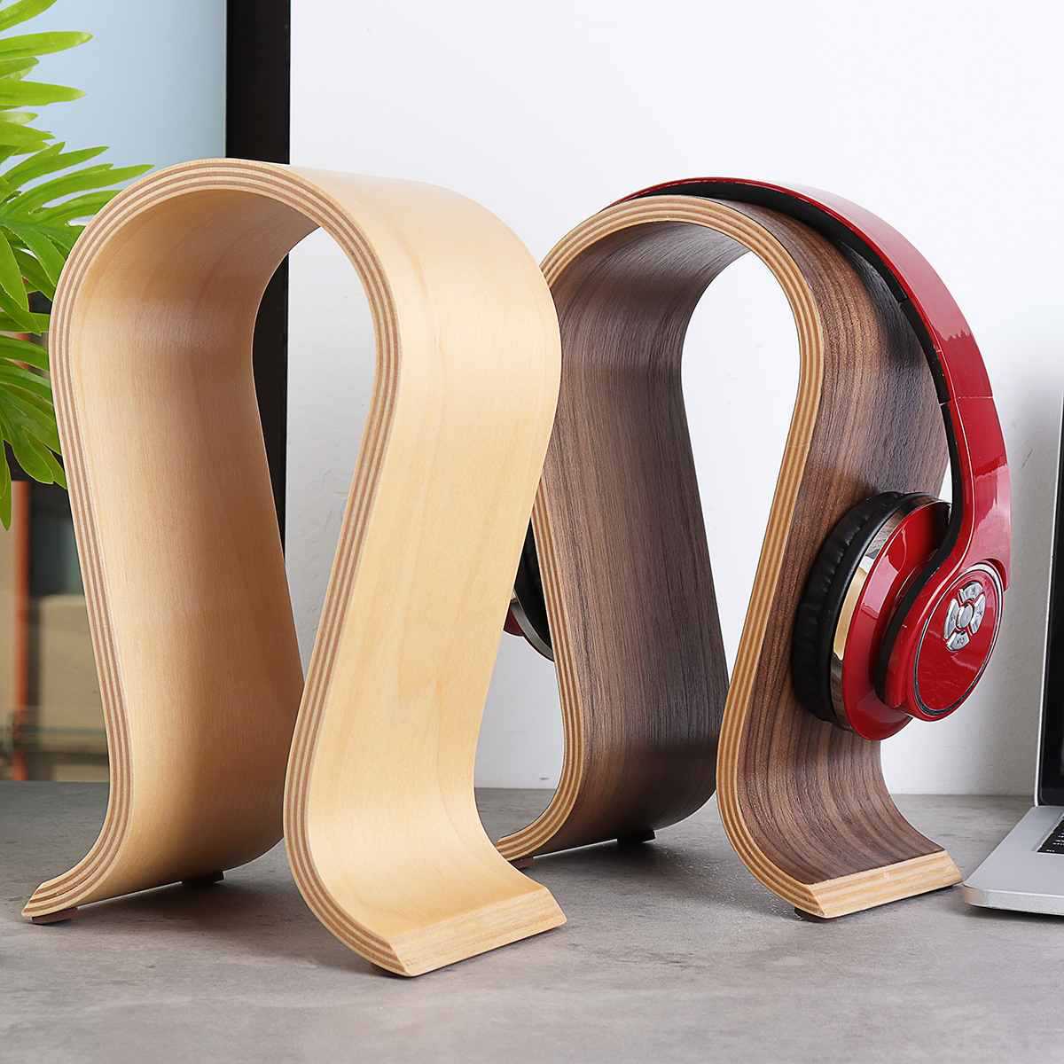 Light wood and walnut-look headphone stands, one holding red headphones