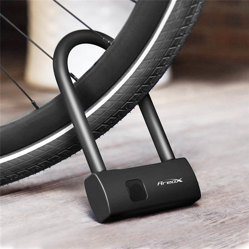 Black U-lock fitted around a bicycle wheel and frame