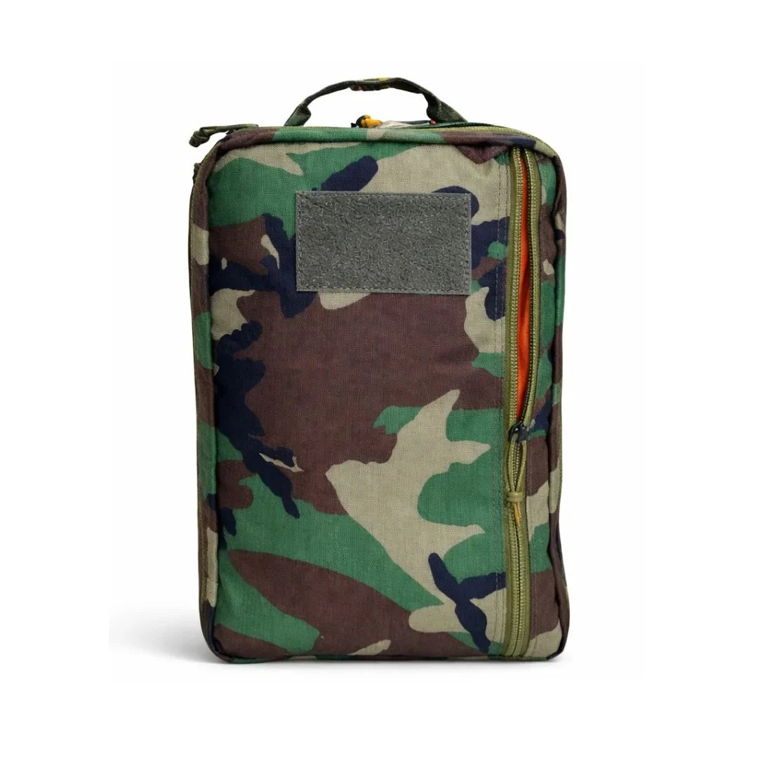 Recycled Firefighter 24 Hour Backpack in woodland camouflage with a gray patch panel and orange zipper edge