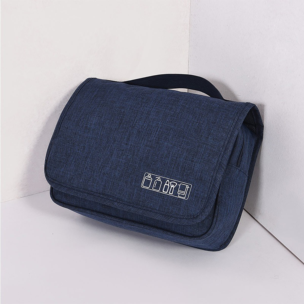 Midnight Navy hanging toiletry bag, folded, with a top carry handle