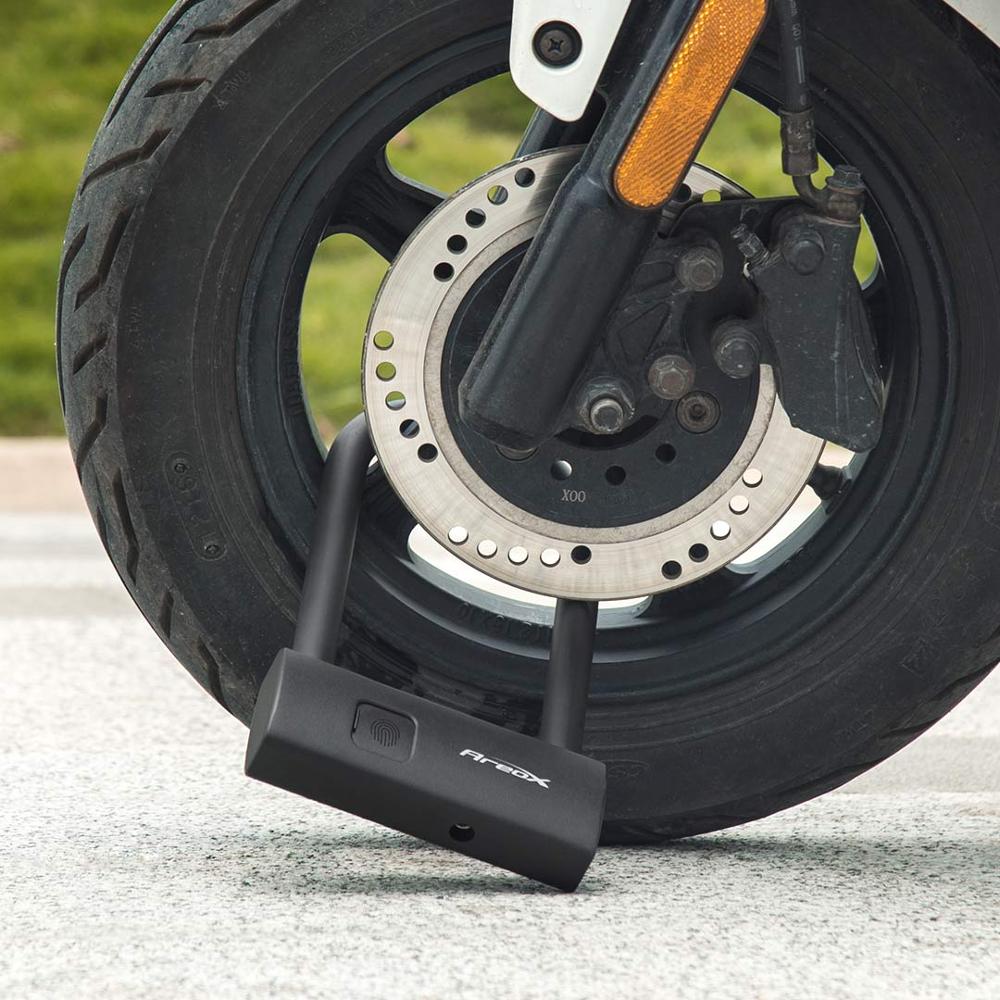 Black U-lock secured around a scooter wheel and brake disc