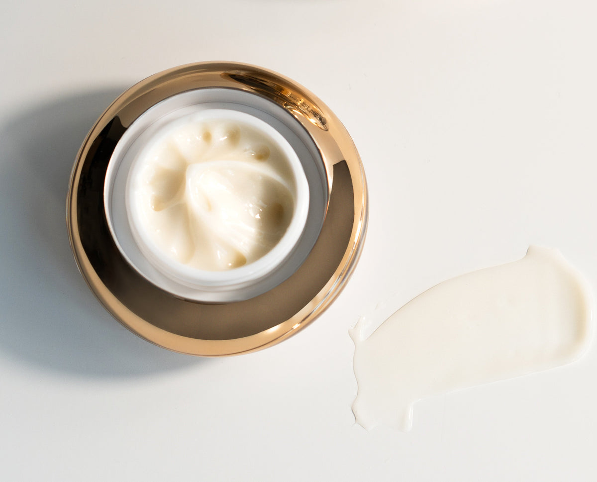 Open EpiLynx eye cream jar showing the cream, with a smear of cream beside it