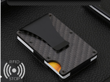 CHICAMOR MagShield metal card holder in black with a carbon-fiber pattern and an RFID Stop symbol, on a dark surface