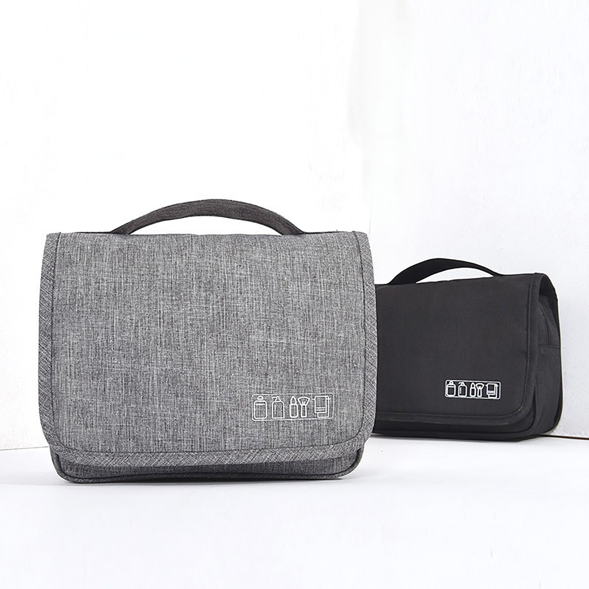 Gray and black folded toiletry bags with top carry handles