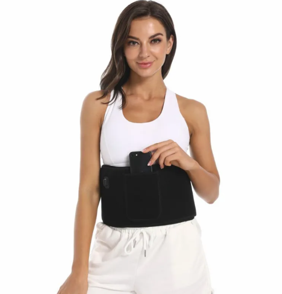 Woman in a white top wearing the black belt around her waist while touching its pocket
