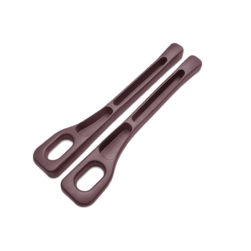 Pair of brown CHICAMOR SeatSlot car seat gap fillers on a white background