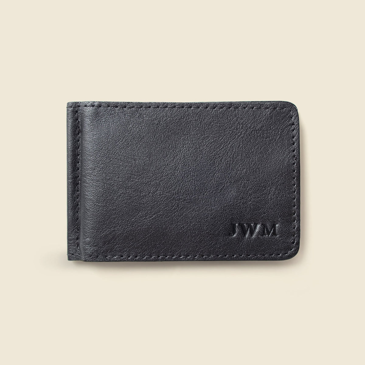 Front of the black leather money clip wallet with initials stamped near the bottom corner