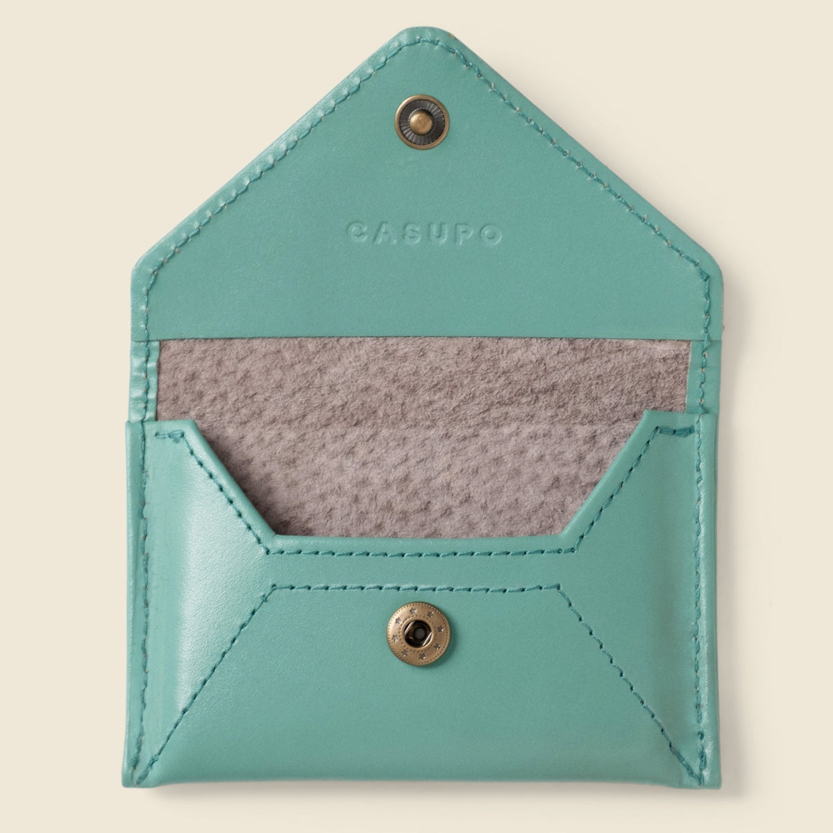 Open empty CASUPO teal mini envelope wallet showing the gray inner lining and snap