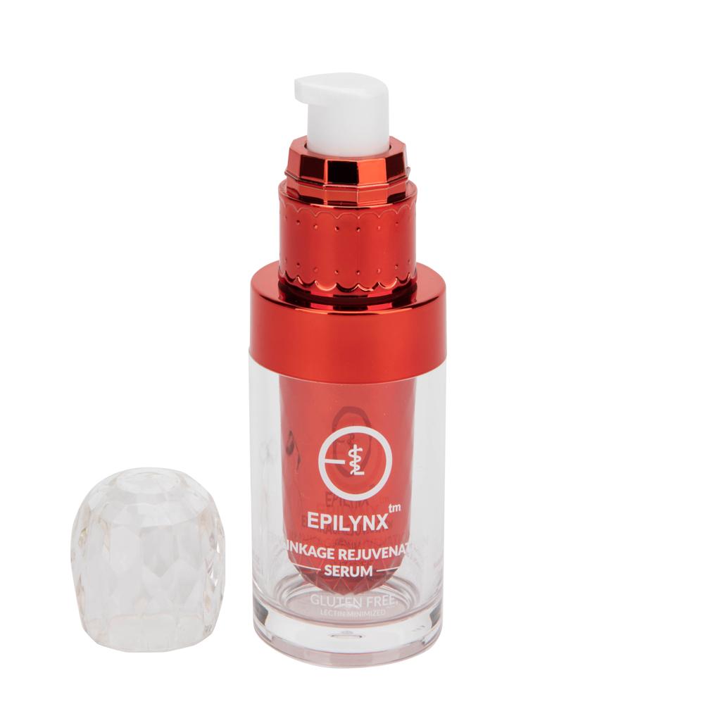 Red serum bottle with its clear crystal-style cap set beside it