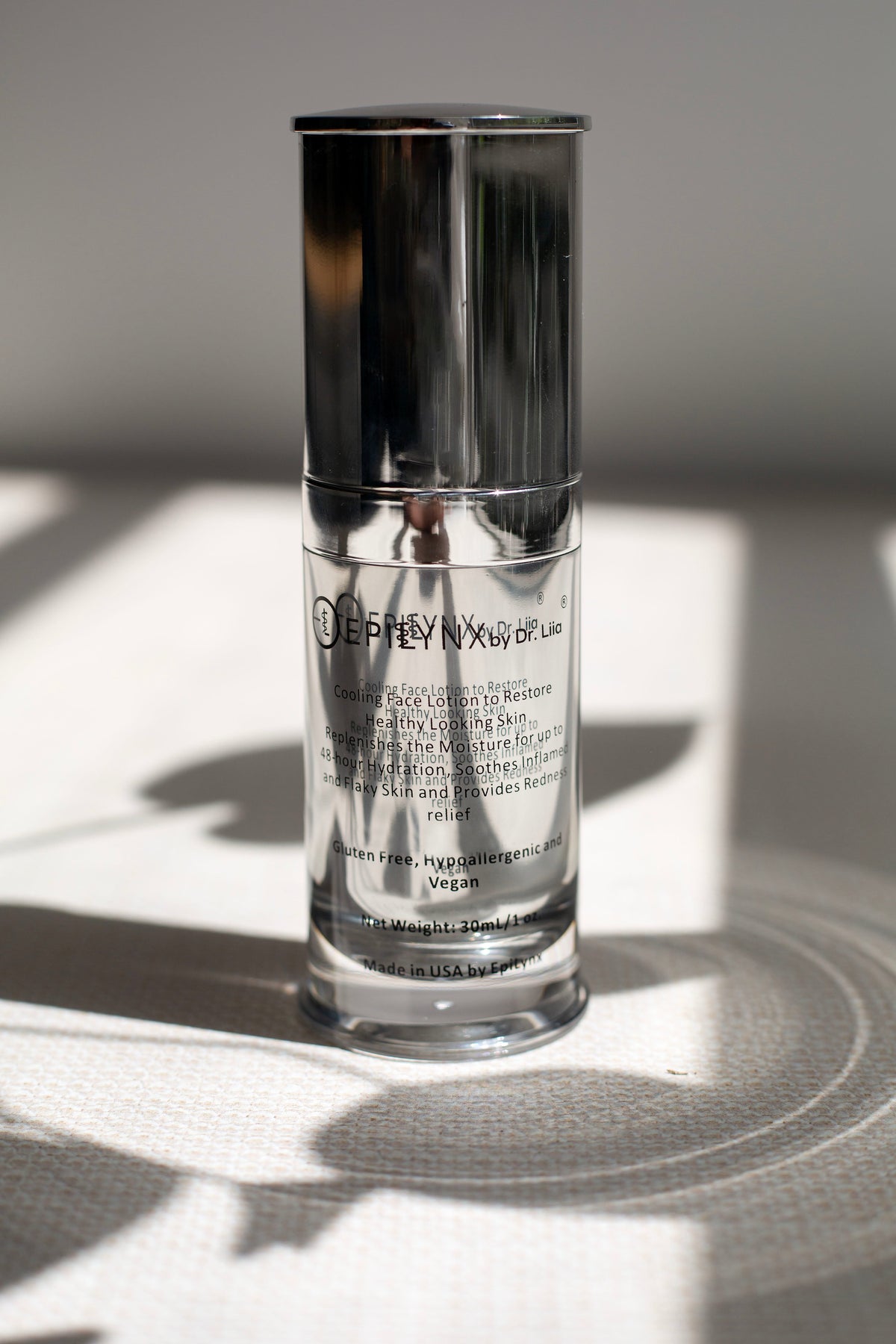 EpiLynx moisturizer silver bottle in soft daylight on a gray surface