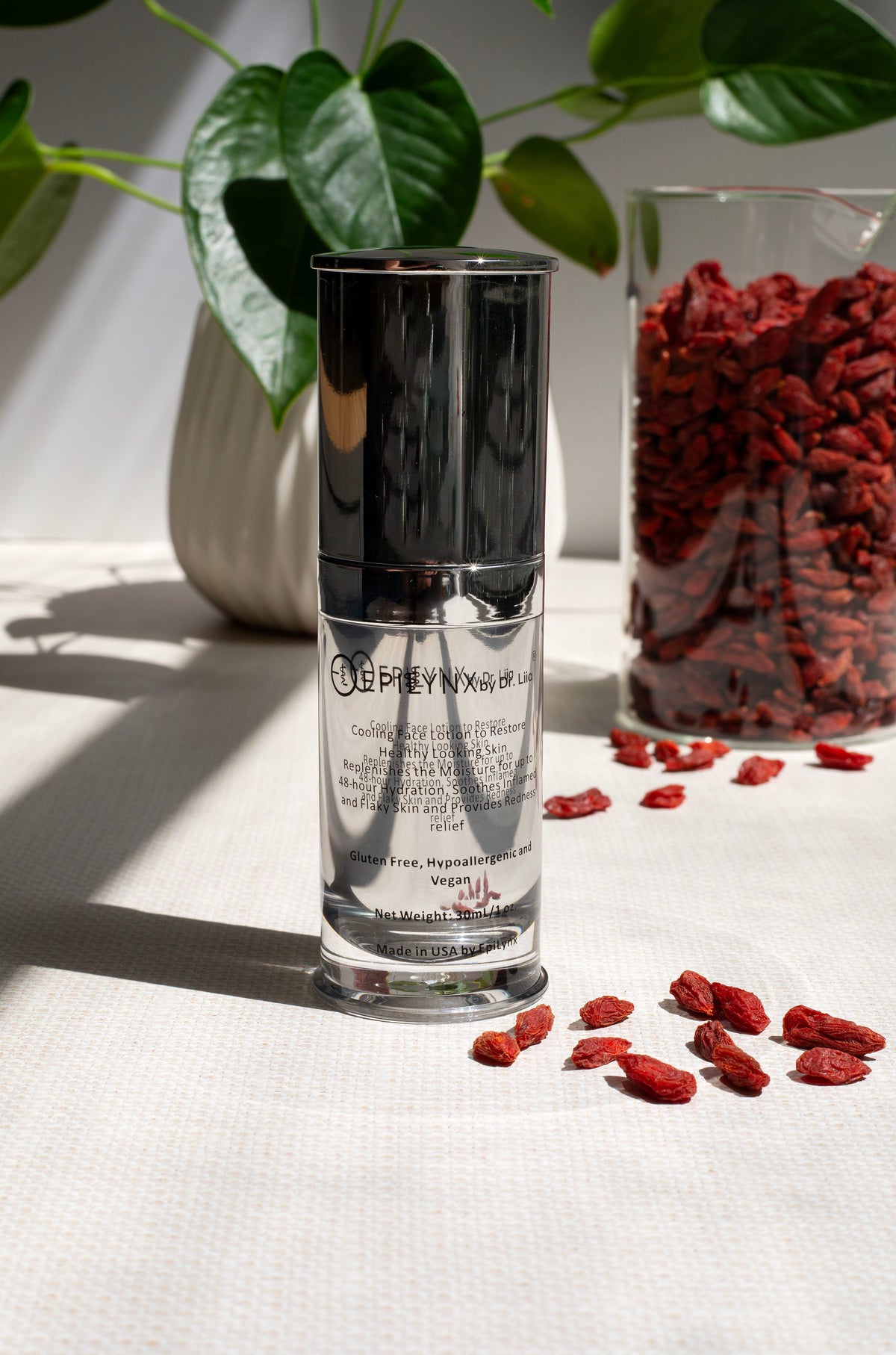 EpiLynx moisturizer bottle beside a green plant and scattered red berries