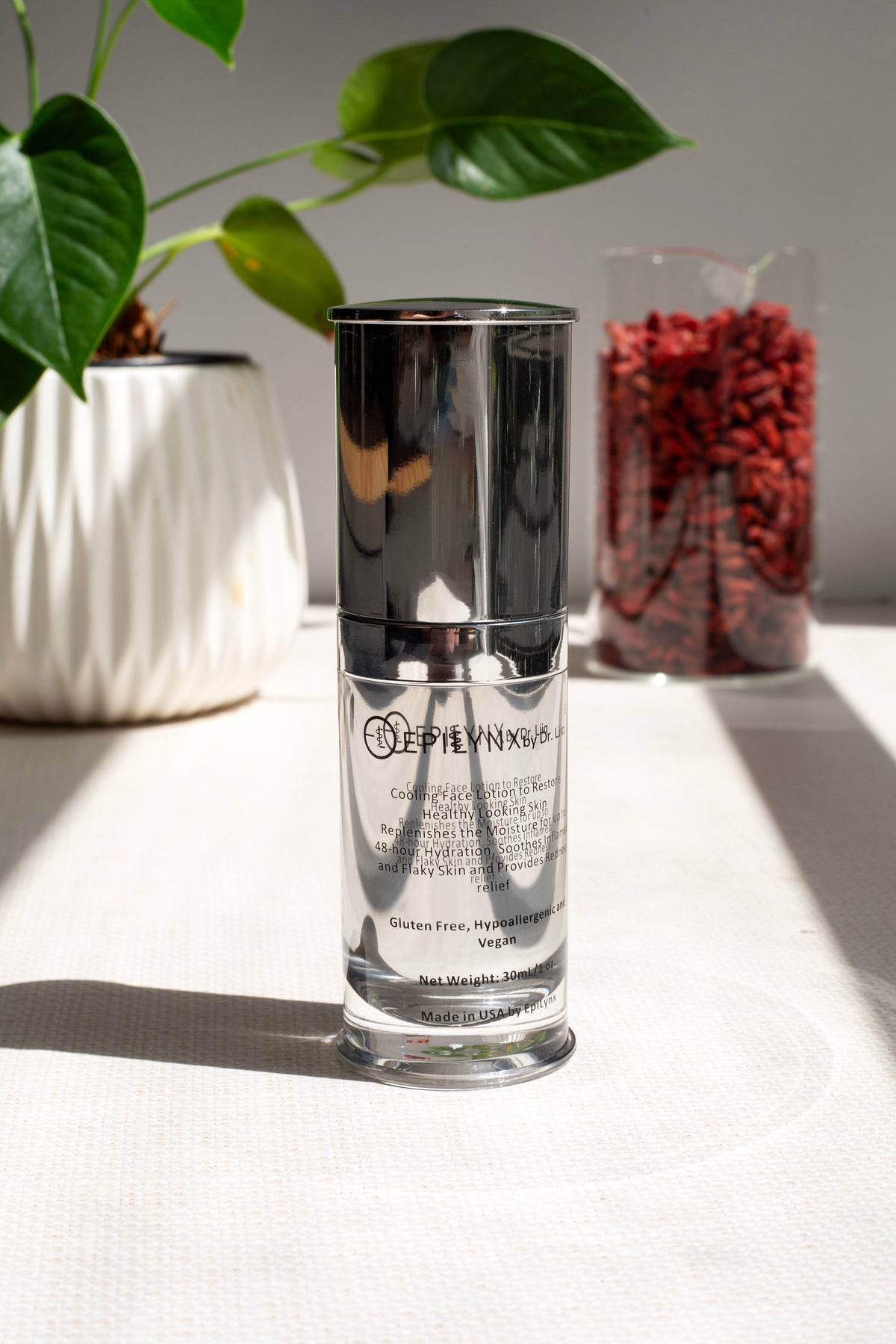 EpiLynx moisturizer bottle on a white surface in front of a mirror and a potted plant