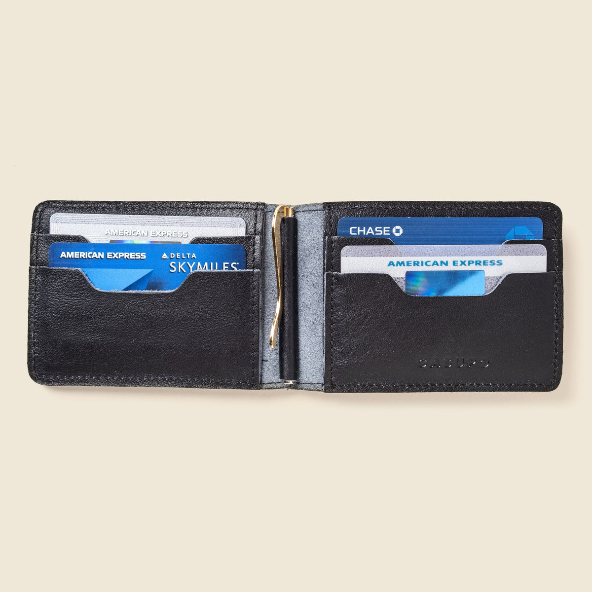 Open black leather wallet with cards in the slots on both sides and a gold clip in the center