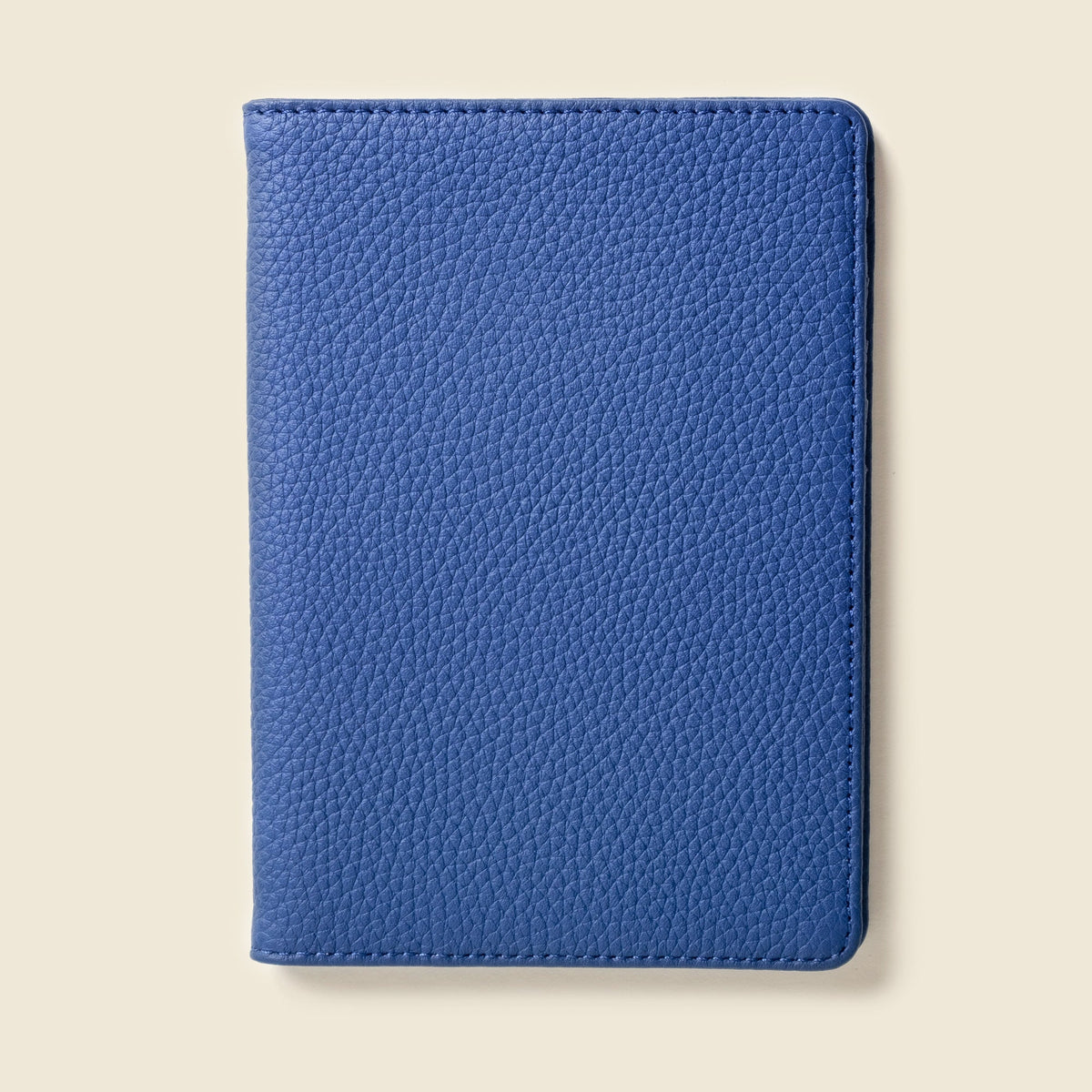 Closed cobalt blue pebbled leather passport wallet, front view