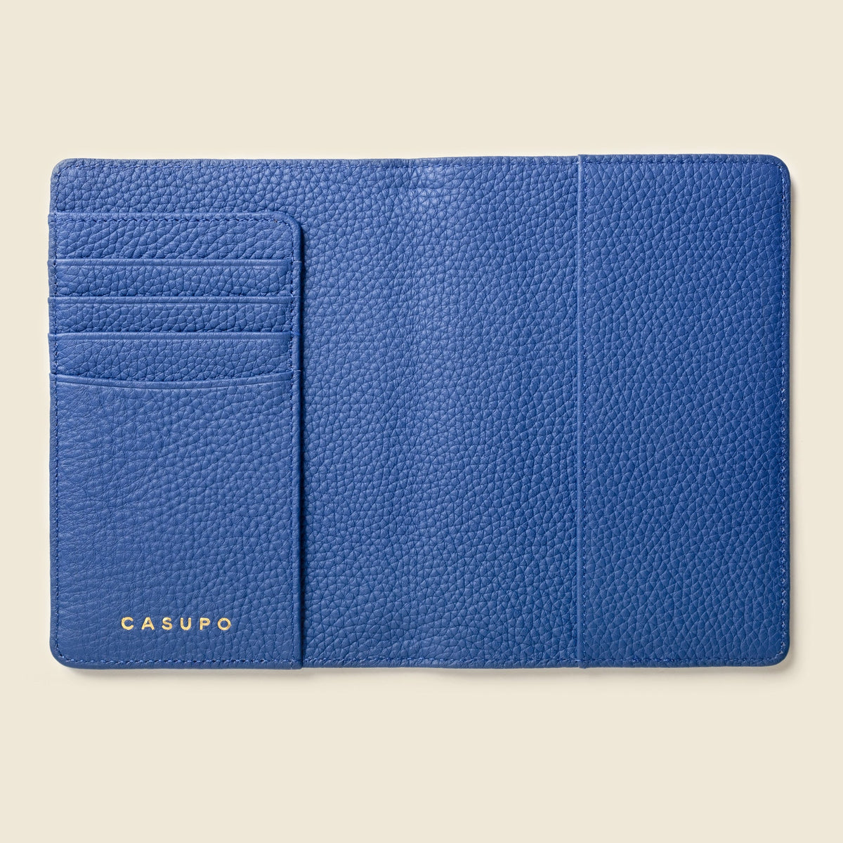 Inside of the cobalt blue passport wallet showing card slots and a center pocket