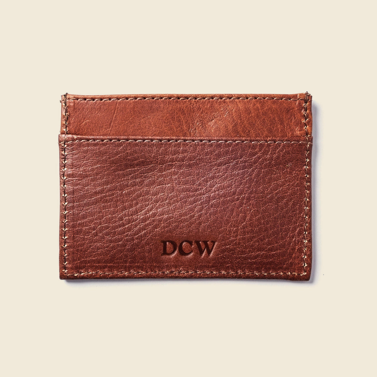 Back of the CASUPO chocolate brown leather card holder with initials stamped on the lower pocket