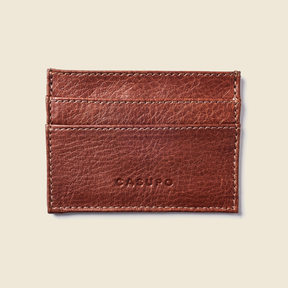 CASUPO slim card holder in chocolate brown leather, front view with an embossed logo
