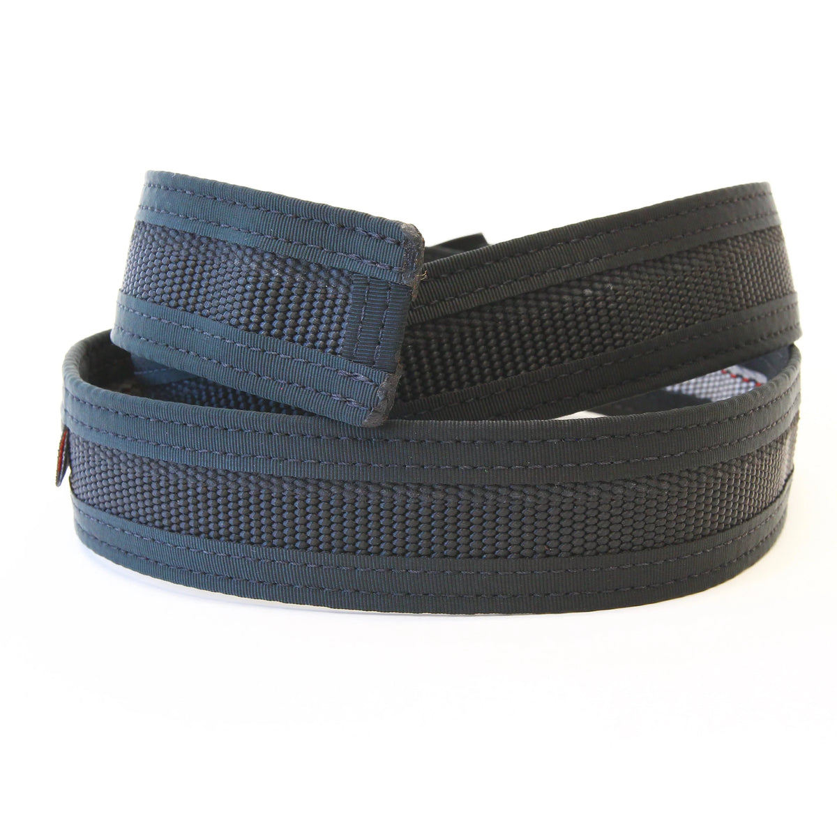 Black Fire Hose EDC Belt coiled on a white background, side view