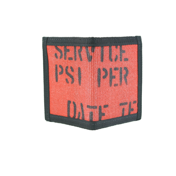 Red-orange fire hose fabric with black stencil lettering shaped as a small pocket