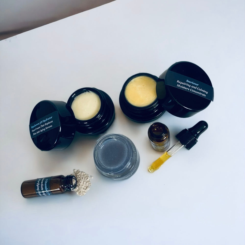 NILCEUTICA discovery kit with black jars, amber dropper bottles and a gray jar on a white surface
