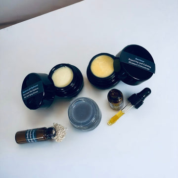 NILCEUTICA discovery kit with black jars, amber dropper bottles and a gray jar on a white surface