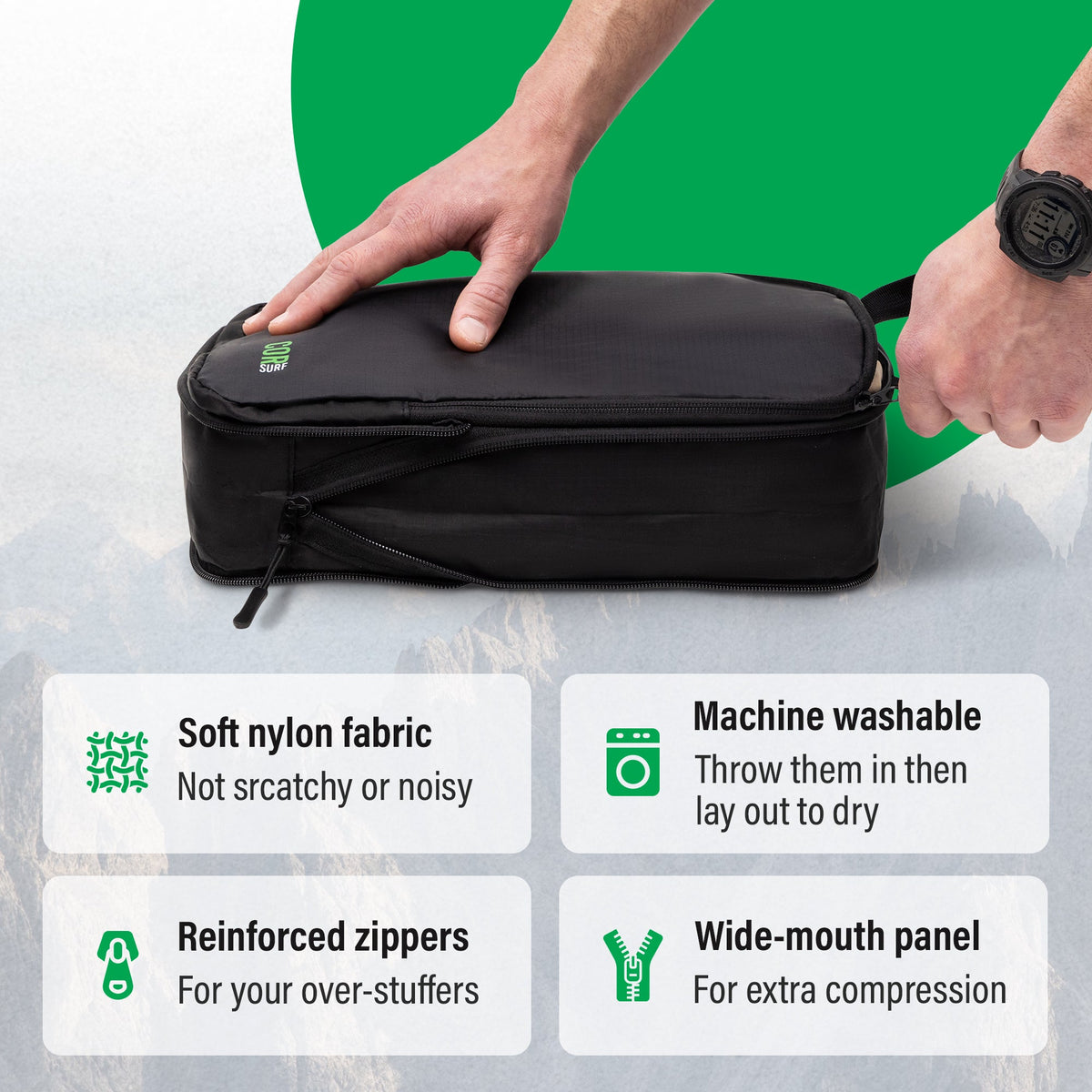 Hand pressing a black packing cube, with callouts for soft nylon fabric, machine washable, reinforced zippers and wide-mouth panel