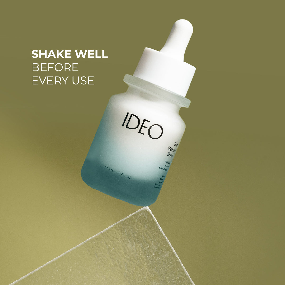 IDEO serum dropper bottle on an olive green background with the text Shake Well Before Every Use