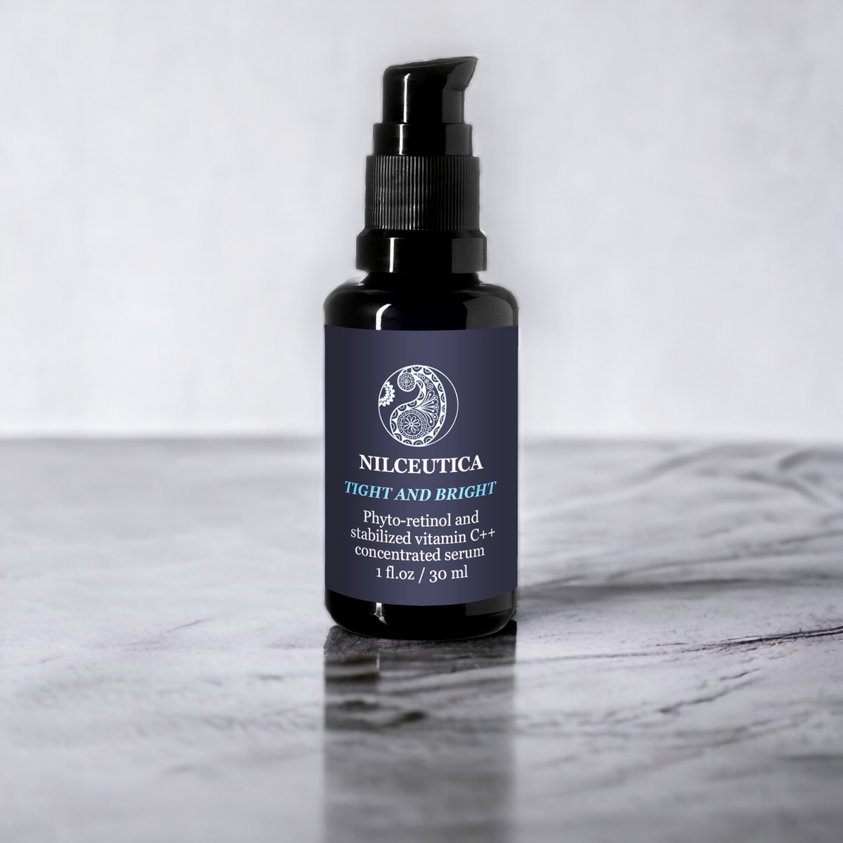 NILCEUTICA dark glass serum bottle with a dropper pump on a gray surface