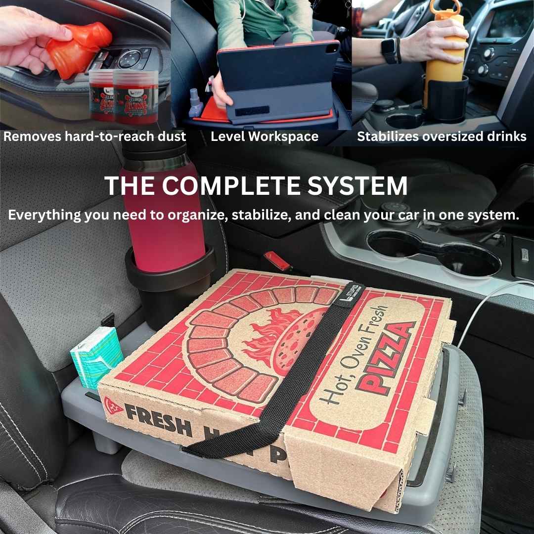 The Professional Workspace in Grey holding a pizza box across a car's front seat, with the text The Complete System
