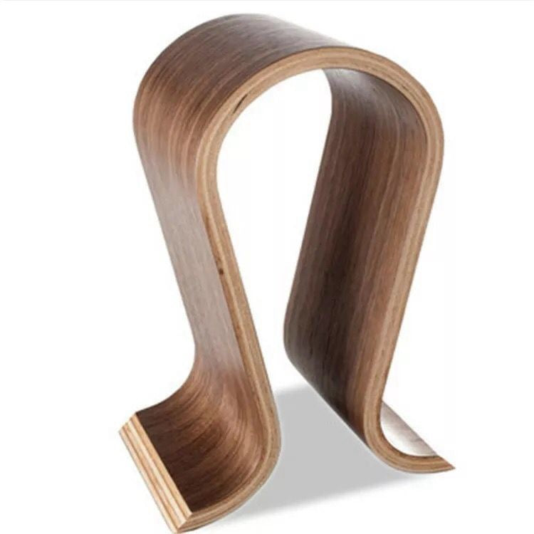 Walnut-look curved wooden headphone stand with a light wood core, angled view