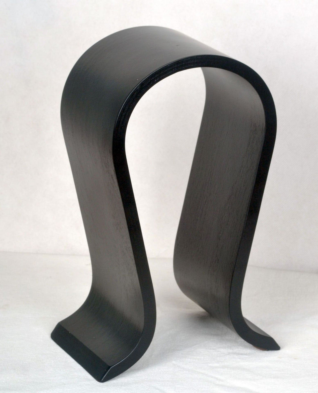 Black curved wooden headphone stand