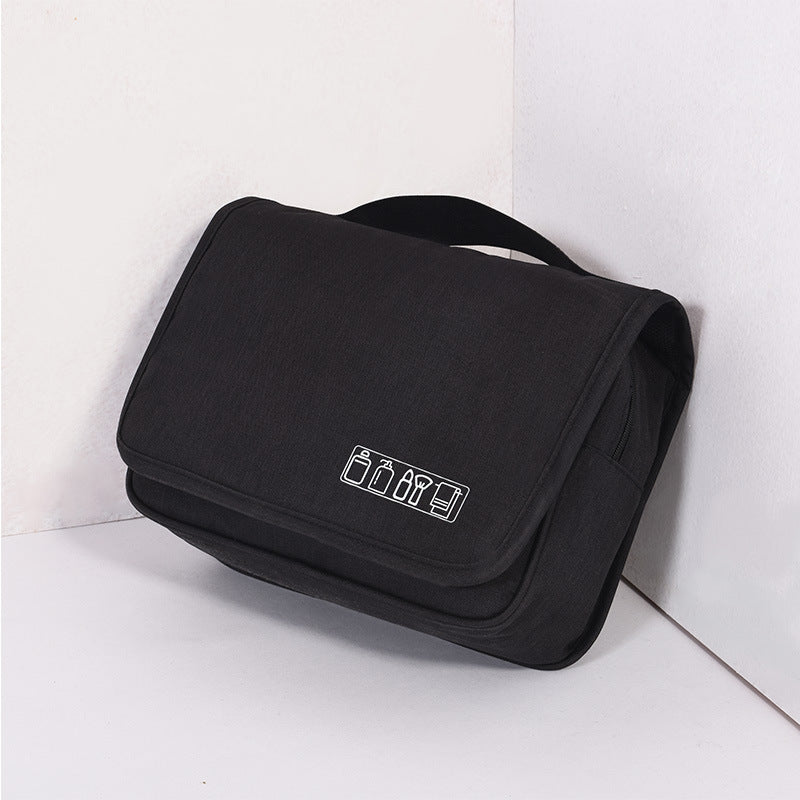 Black hanging toiletry bag, folded, with a top carry handle