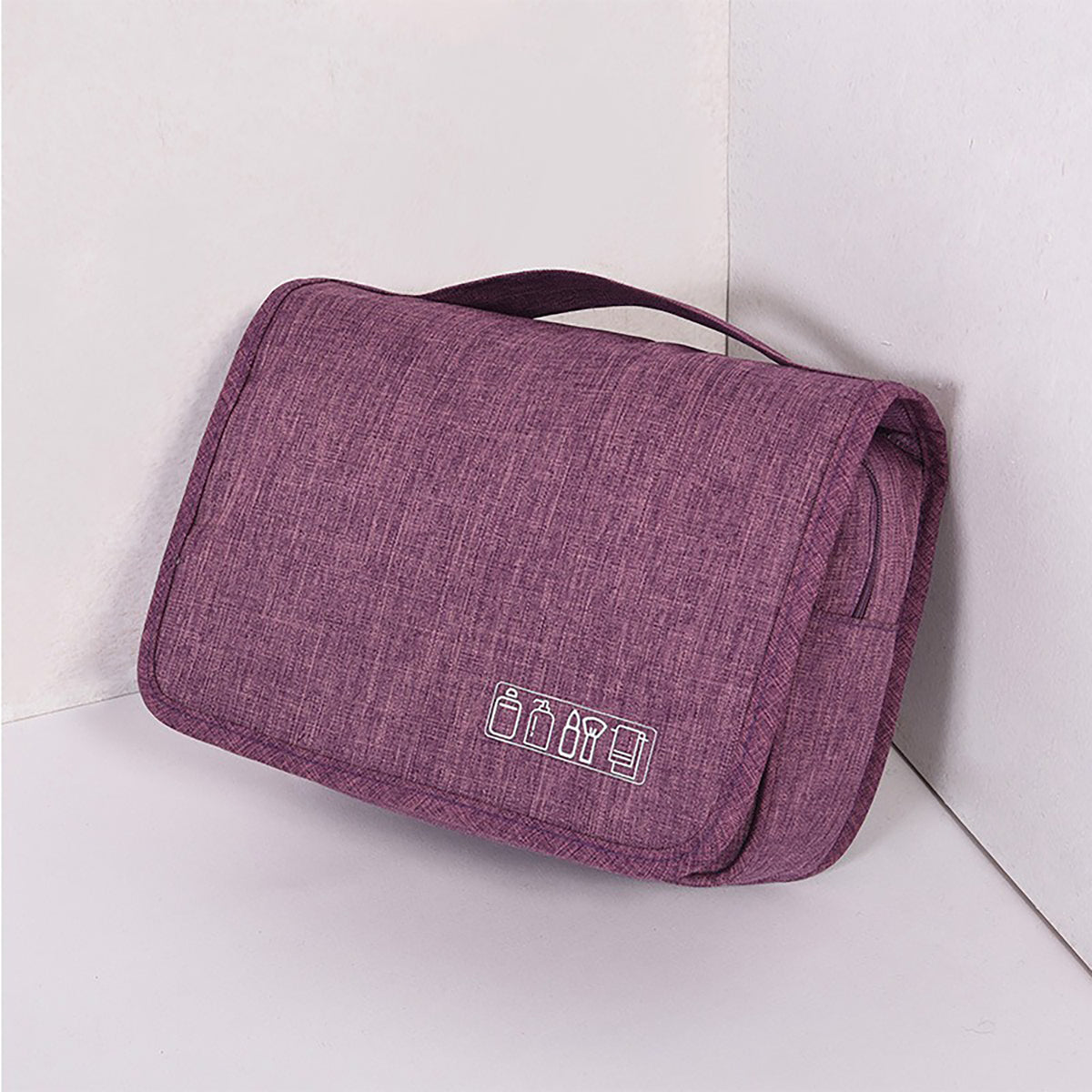 Purple toiletry bag, folded, with a top carry handle
