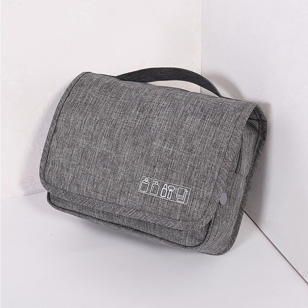 Gray hanging toiletry bag, folded, with a top carry handle