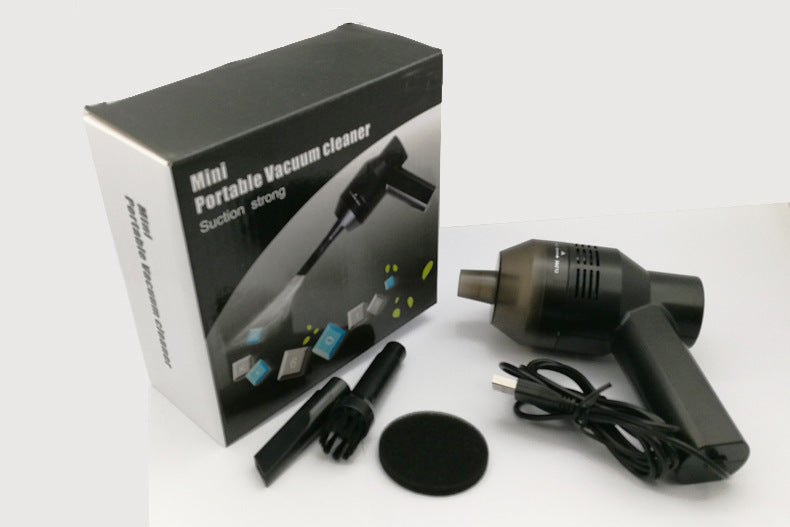 Mini portable vacuum cleaner retail box beside the vacuum, brush attachments and cable