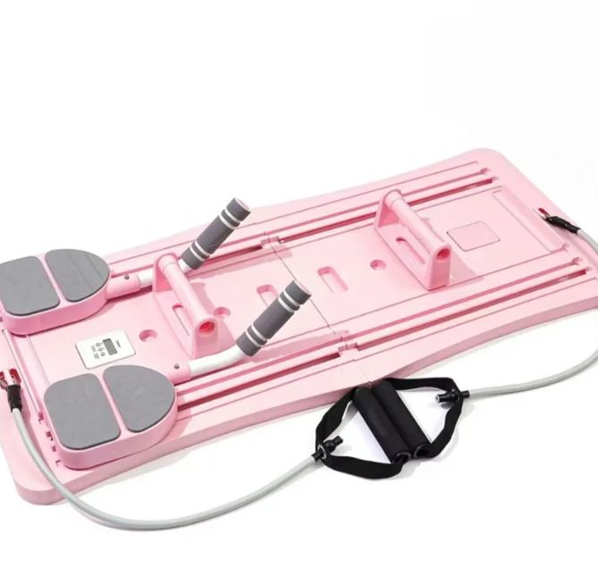 Pink foldable pilates slider board with foot pads, resistance tubes and small weights