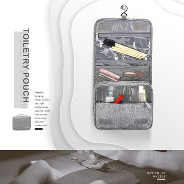 Gray hanging toiletry bag open on its hook, showing toiletries in the clear and mesh pockets