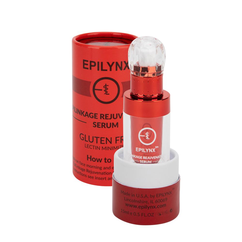 Red serum bottle with a crystal-style cap in front of its red cylindrical box